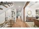 Hallway with wood floors, built-in shelves, and access to dining and living areas creates a seamless flow at 1621 Legacy Ridge Ln, Wake Forest, NC 27587