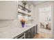 Butler's pantry with stone countertop, storage, and wine fridge at 1621 Legacy Ridge Ln, Wake Forest, NC 27587