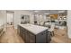 Gourmet kitchen with large island, stone counters, gold faucet, and stainless steel appliances at 1621 Legacy Ridge Ln, Wake Forest, NC 27587