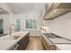 Modern kitchen featuring stone countertops, custom cabinetry, and stainless steel appliances at 1621 Legacy Ridge Ln, Wake Forest, NC 27587