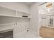 Bright laundry room features marble floors, built-in shelves, and a doorway to a walk-in closet at 1621 Legacy Ridge Ln, Wake Forest, NC 27587