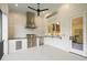 An outdoor kitchen featuring a stainless steel grill, beverage fridge, and brick backsplash at 1621 Legacy Ridge Ln, Wake Forest, NC 27587