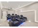 In-home theater features comfortable seating with drink holders, tiered platforms, and custom lighting at 1621 Legacy Ridge Ln, Wake Forest, NC 27587