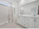 Modern bathroom featuring double sinks, a glass shower, and white cabinetry at 814 Barlow Dr, Knightdale, NC 27545