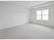 Bright bedroom featuring neutral carpeting, recessed lighting, and a large window at 814 Barlow Dr, Knightdale, NC 27545