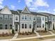 Charming new construction townhomes with gray and white exteriors and manicured landscaping at 814 Barlow Dr, Knightdale, NC 27545