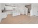 Open concept kitchen with white cabinets, stainless appliances, island, and hardwood floors at 814 Barlow Dr, Knightdale, NC 27545