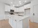 Bright kitchen features white cabinets, stainless appliances, and an island with a sink at 814 Barlow Dr, Knightdale, NC 27545