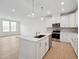 Bright kitchen features white cabinets, stainless appliances, and an island with a sink at 814 Barlow Dr, Knightdale, NC 27545