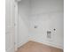 Bright laundry room with connections for a washer and dryer, plus shelf at 814 Barlow Dr, Knightdale, NC 27545