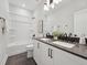 Well-lit bathroom featuring double sinks, dark hardware, and a shower-tub combo at 1505 Patchings Ln, Knightdale, NC 27545