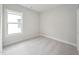 Clean and bright bedroom with neutral carpet and trim and a large window for natural light at 1505 Patchings Ln, Knightdale, NC 27545