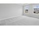 Bright bedroom with carpeted floors and large windows at 1505 Patchings Ln, Knightdale, NC 27545