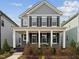Charming two-story home with a covered front porch, white columns, and landscaped yard at 1505 Patchings Ln, Knightdale, NC 27545
