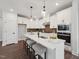 Modern kitchen with white cabinets, stainless steel appliances, and an island with bar stool seating at 1505 Patchings Ln, Knightdale, NC 27545