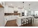 Modern kitchen featuring white cabinets, stainless steel appliances, and a central island with barstools at 1505 Patchings Ln, Knightdale, NC 27545