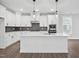 Modern kitchen boasts white cabinets, quartz countertops, island and stainless steel appliances at 1505 Patchings Ln, Knightdale, NC 27545