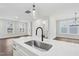 Kitchen island with sink, modern faucet, and quartz countertop at 1505 Patchings Ln, Knightdale, NC 27545