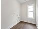 Functional laundry room with wood-look flooring, a window for natural light, and washer/dryer hookups at 1505 Patchings Ln, Knightdale, NC 27545