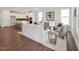 Bright, open-concept living room with wood floors, a modern sofa, and an adjacent eat-in kitchen at 1505 Patchings Ln, Knightdale, NC 27545