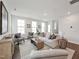 Comfortable living room featuring a plush sofa, two chairs, natural light, and wood-look flooring at 1505 Patchings Ln, Knightdale, NC 27545