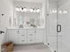 Elegant main bathroom featuring a double vanity, a large mirror, and a frameless glass shower at 1505 Patchings Ln, Knightdale, NC 27545