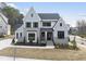 Charming two-story home with light blue siding, black trim, and a manicured front lawn at 9400 Rawson Ave, Raleigh, NC 27613