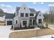 Beautiful two-story home with light blue siding, black trim, and a manicured front lawn at 9400 Rawson Ave, Raleigh, NC 27613
