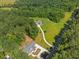 Aerial view of new home on wooded lot with long driveway at 3691 Graham Sherron Rd, Wake Forest, NC 27587