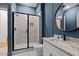 Bathroom featuring tile shower with glass door, toilet, vanity with sink, and a round mirror at 3691 Graham Sherron Rd, Wake Forest, NC 27587