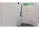 Modern walk-in shower with sleek fixtures, a bench seat, and light tile at 3691 Graham Sherron Rd, Wake Forest, NC 27587