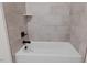 Close up view of a white bathtub with neutral tile and black hardware at 3691 Graham Sherron Rd, Wake Forest, NC 27587