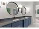 Modern bathroom features double vanity with black granite countertops and round mirrors at 3691 Graham Sherron Rd, Wake Forest, NC 27587