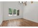 Bright, airy bedroom featuring large window with backyard tree view and hardwood floors at 3691 Graham Sherron Rd, Wake Forest, NC 27587