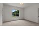 Bedroom with neutral carpet, white walls, and a large window at 3691 Graham Sherron Rd, Wake Forest, NC 27587