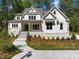 Stunning exterior with white siding, stone accents, and a well-manicured front yard and landscaping at 3691 Graham Sherron Rd, Wake Forest, NC 27587