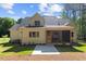 Rear exterior view of home with neutral siding, screened in porch, and wooded backdrop at 3691 Graham Sherron Rd, Wake Forest, NC 27587