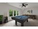 Game room with pool table, bar, and large windows with a view of trees at 3691 Graham Sherron Rd, Wake Forest, NC 27587