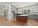 Beautiful kitchen with hardwood floors, center island, stainless steel appliances, and view of the backyard at 3691 Graham Sherron Rd, Wake Forest, NC 27587