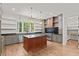 Spacious kitchen featuring hardwood floors, a center island, stainless steel appliances, and ample counter space at 3691 Graham Sherron Rd, Wake Forest, NC 27587
