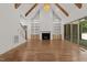 Inviting living room with vaulted ceiling, exposed beams, fireplace and large windows at 3691 Graham Sherron Rd, Wake Forest, NC 27587