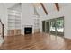 Bright living room featuring fireplace, built-in bookshelves, and sliding glass doors at 3691 Graham Sherron Rd, Wake Forest, NC 27587
