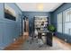 Elegant office with hardwood floors, wainscotting, modern lighting, and view of the backyard at 3691 Graham Sherron Rd, Wake Forest, NC 27587