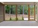 Screened porch offers peaceful view into wooded backyard and easy access to outdoors at 3691 Graham Sherron Rd, Wake Forest, NC 27587