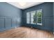 Elegant room with hardwood floors, wainscotting, recessed lighting and a large window at 3691 Graham Sherron Rd, Wake Forest, NC 27587