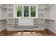 Spacious walk-in closet featuring built-in shelving and plenty of natural light from large windows at 3691 Graham Sherron Rd, Wake Forest, NC 27587