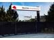 View of the Red Hat Amphitheater sign surrounded by greenery and fencing at 618 Velma Hopkins Ln, Raleigh, NC 27603