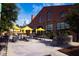Outdoor dining area at a brick building featuring string lights and yellow umbrellas at 618 Velma Hopkins Ln, Raleigh, NC 27603