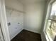 Functional laundry room with washer/dryer connections, storage shelf, and natural light from the window at 112 Ambergate Ct, Rocky Mount, NC 27804