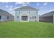 Spacious backyard with a large grassy area and patio at 292 Chestnut Oak Ln, Lillington, NC 27546